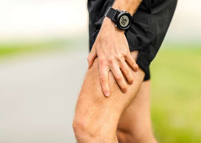 Muscle injury in leg. Man holding his leg in pain.