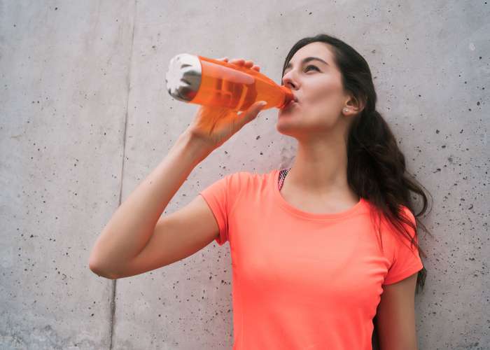 Drink water for IBD: woman drinking water.