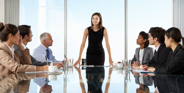 Group Of Business People Having Board Meeting Around Glass Table