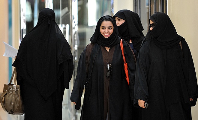 Saudi women walk inside the ‘Faysalia’ m