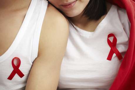 AIDS awareness ribbon pinned on chests of young people