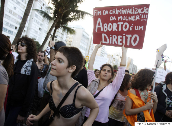 People participate in the SlutWalk protest on Copacabana Beach, where Pope Francis will celebrate mass at night, in Rio de Janeiro