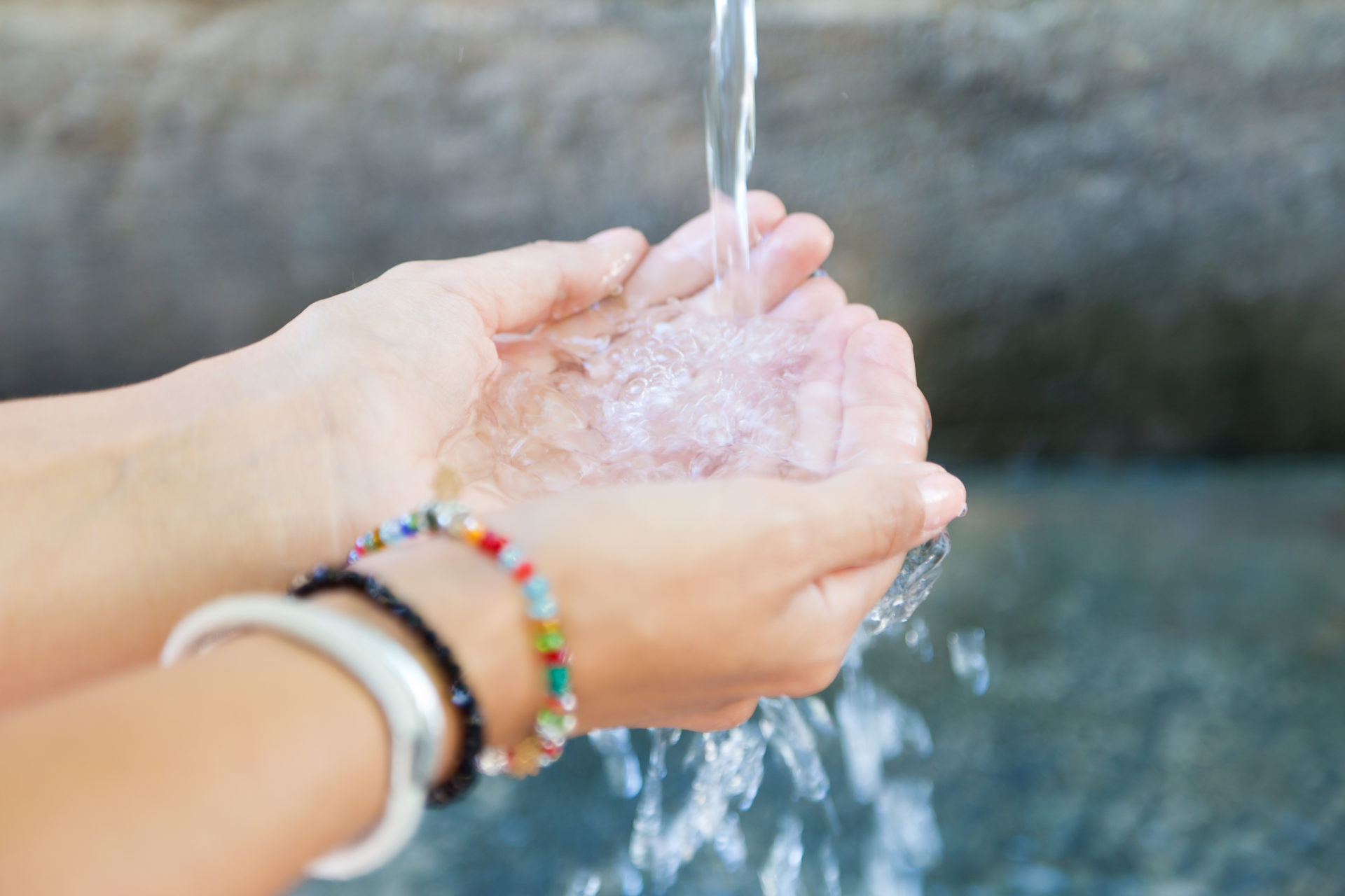 Woman’s hands with water splash.