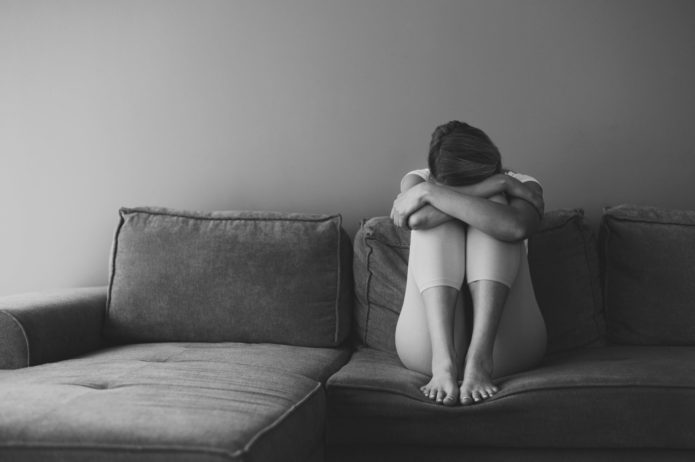 full-shot-woman-sitting-couch