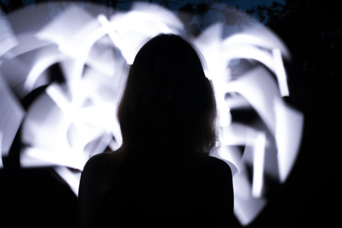 back-view-woman-with-white-light