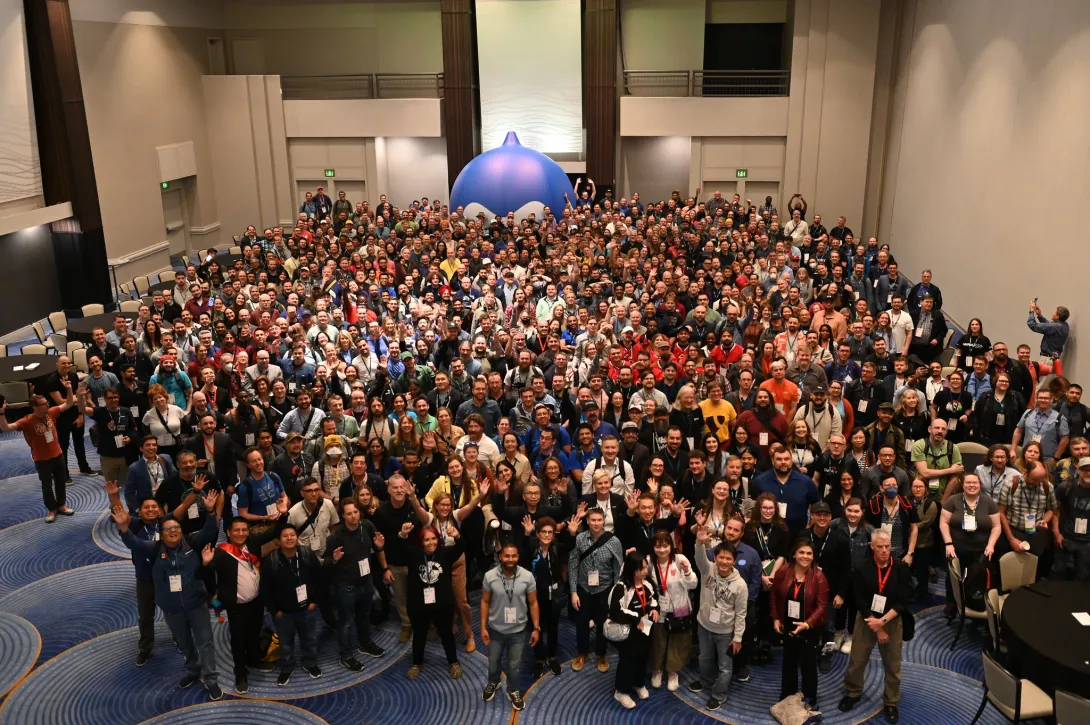 DrupalCon Atlanta 2025 group photo with a giant Druplicon in the very back