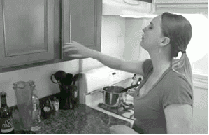 Informercial gif of a woman dropping spice jars out of her cabinet.