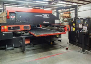 CNC turret punching machine inside PEKO’s sheet metal fabrication facility for flat sheet processing and punched features.