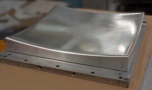 Concave precision machined metal part
