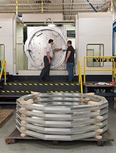 large parts cnc machining with workers checking part in large machine