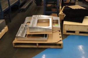 3 cnc machined parts on top of pallet ready for shipment 