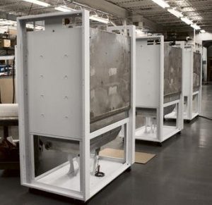 3 white machines in a low-volume production setting