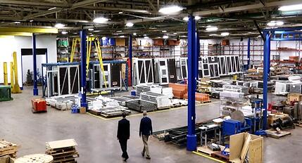 Two men walking through manufacturing floor in the production area 