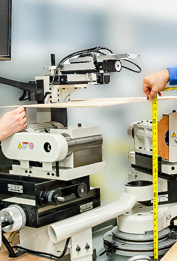 Engineers measuring and reviewing prototype hardware during product development