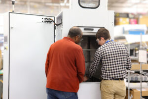 Engineers reviewing a prototype equipment assembly during hardware development