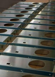 CNC turret punched sheet metal components with round holes, square cutouts, and formed bends for OEM production fabrication