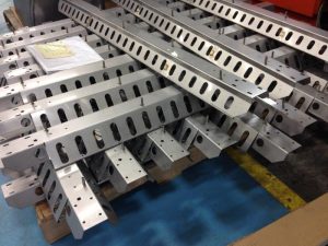 Formed sheet metal rails with repeatable slots and punched openings produced through automated sheet metal punching.