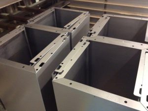 Powder-coated cabinet components with enclosure-style geometry