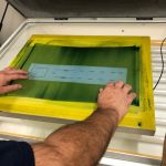 placing transfer on silk screen in UV exposure