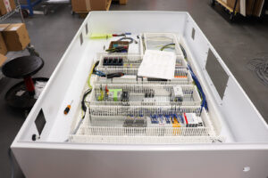 Prototype engineering of electrical controls panel enclosure with PLC integration and programming