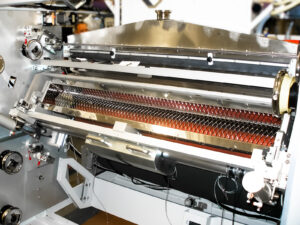 Close-up of a custom automation machine for printing process, including a welded frame and various metal components.