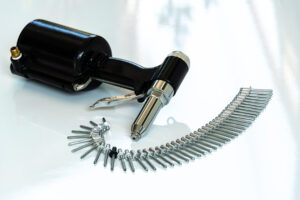 Pneumatic Rivet Gun and Pop Rivets Close Up On White Background