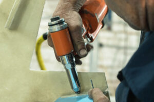 Close-up of a pneumatic riveting tool