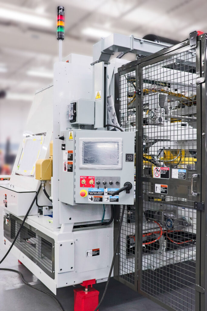 Industrial printing system featuring servo motion control, e-stop circuitry, and interlocked guarding—engineered and built to OEM specifications in PEKO’s manufacturing facility.
