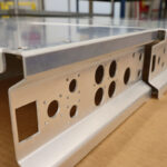 Aluminum panel component with laser-cut holes and formed flanges for sheet metal bending and panel bending applications