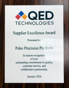 PEKO Precision Products receiving QED Technologies Supplier Excellence Award January 2026