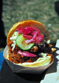 Mighty Quinn`s pulled pork sandwich with pickled onions at Smorgasburg, Brooklyn, NY