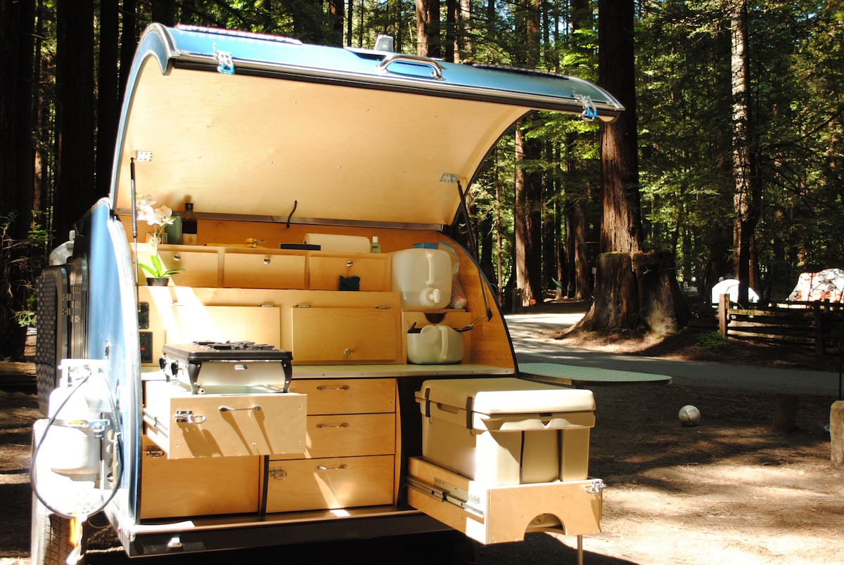 Kitchen of a teardrop trailer at a campsite in Redwood Forest