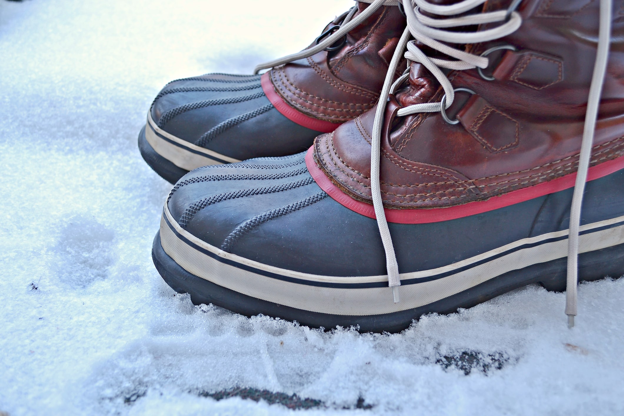 Men's snow boots standing on snow outdoors