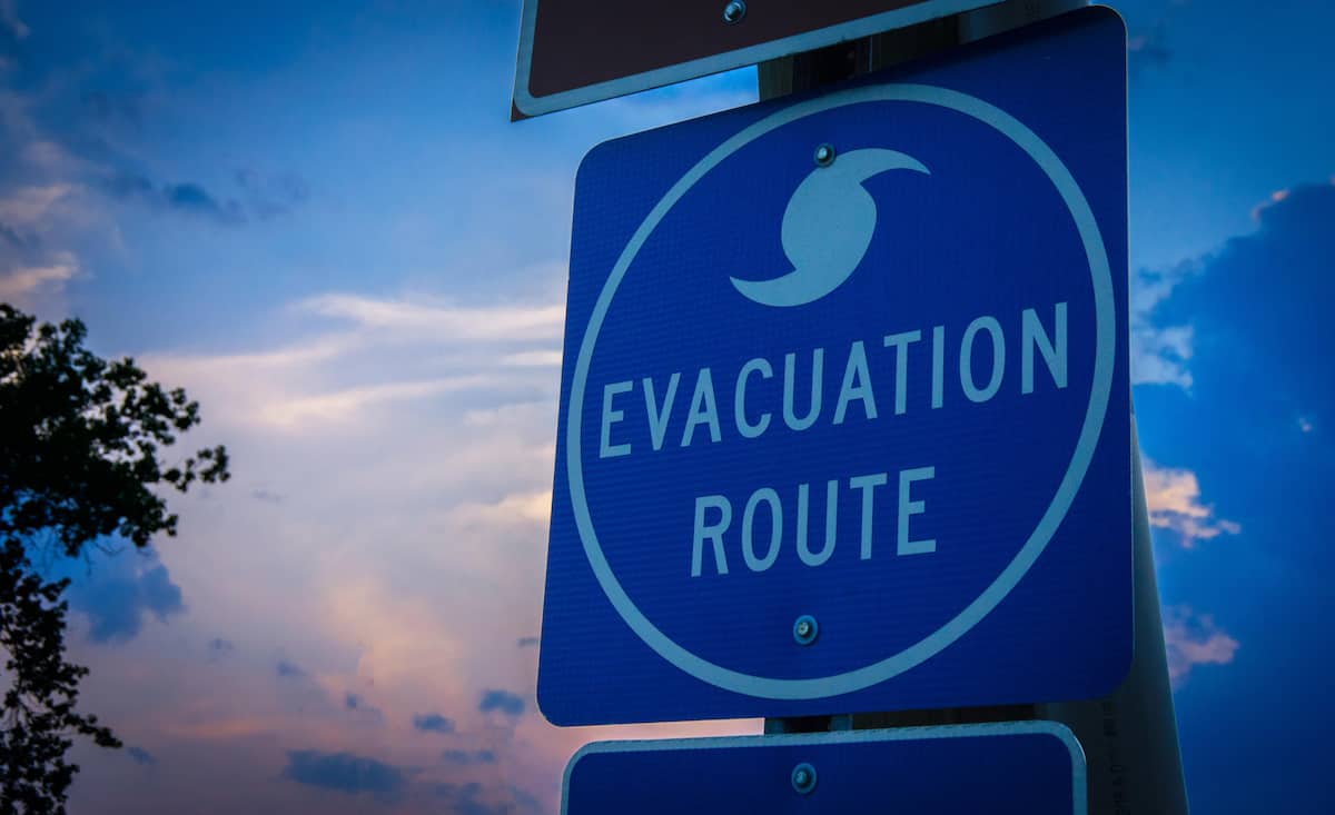 A highway road sign directs weather evacuees to safety.