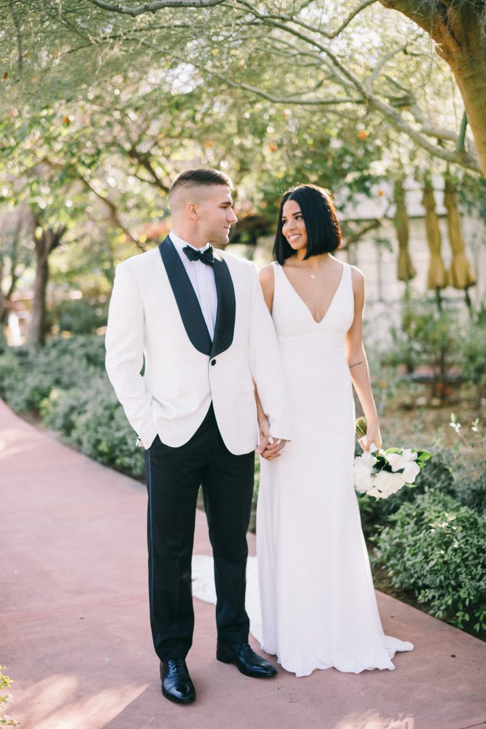 Groom Walking with Bride Wearing Simple Sheath Wedding Dress Called Fernanda by Maggie Sottero