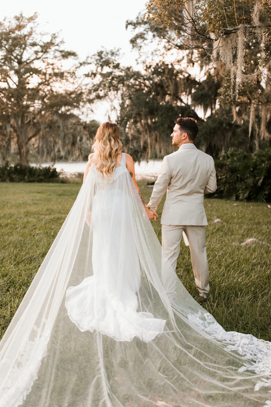 Groom Walking with Real Bride Wearing Bridal Cape and Maggie Sottero Wedding Dress