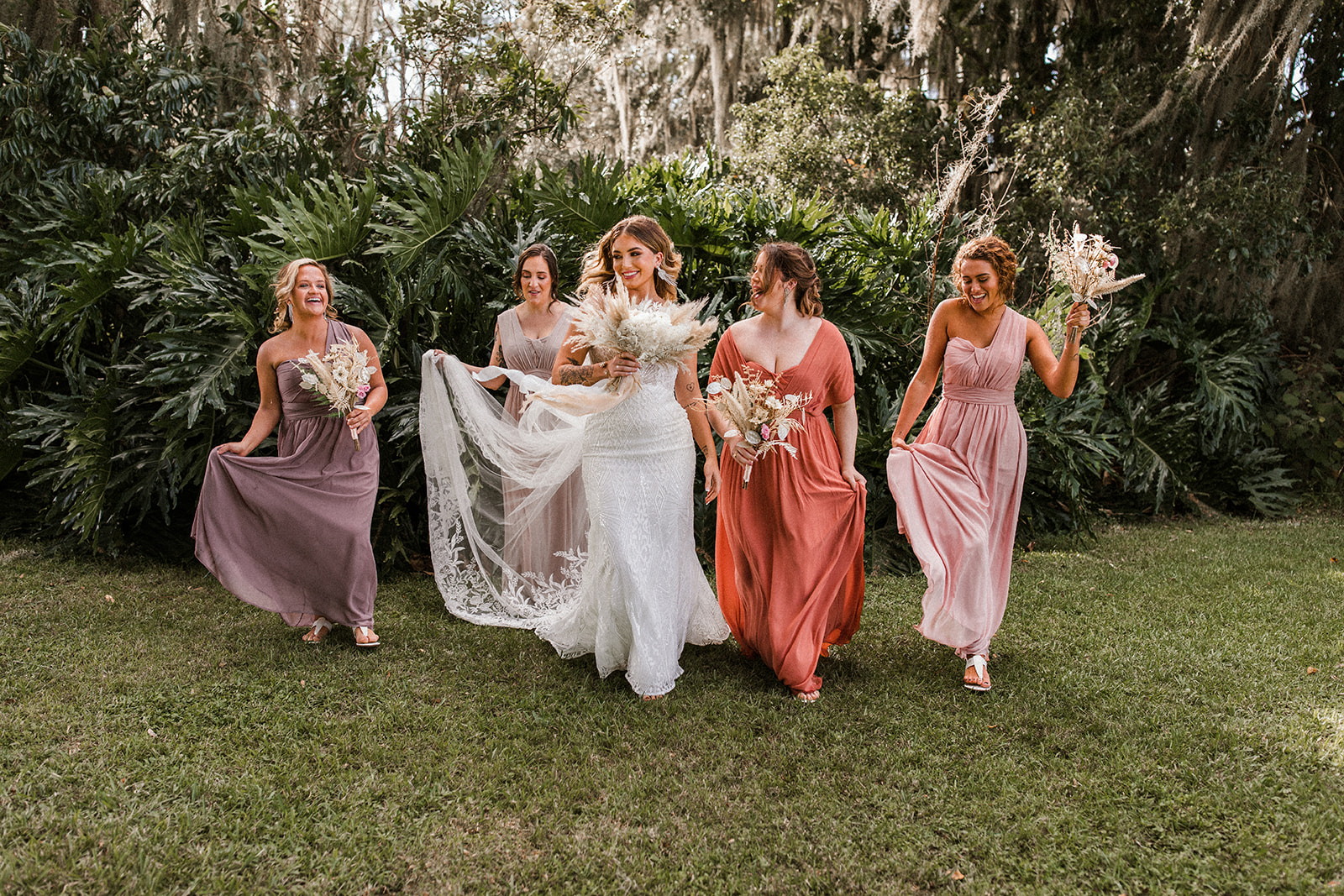 Bridesmaids in Mismatched Gowns Walking with Real Bride Wearing Maggie Sottero Sheath Wedding Dress