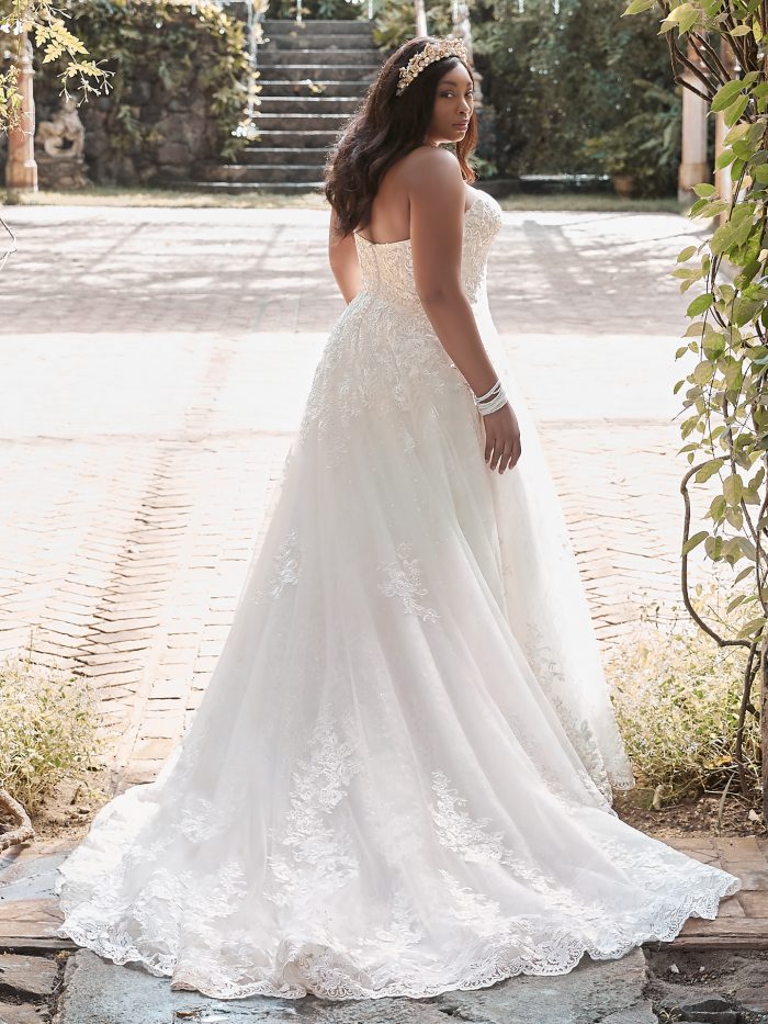 Plus Size Model Wearing Curvy Strapless Lace Ball Gown Wedding Dress Called Tennyson by Maggie Sottero