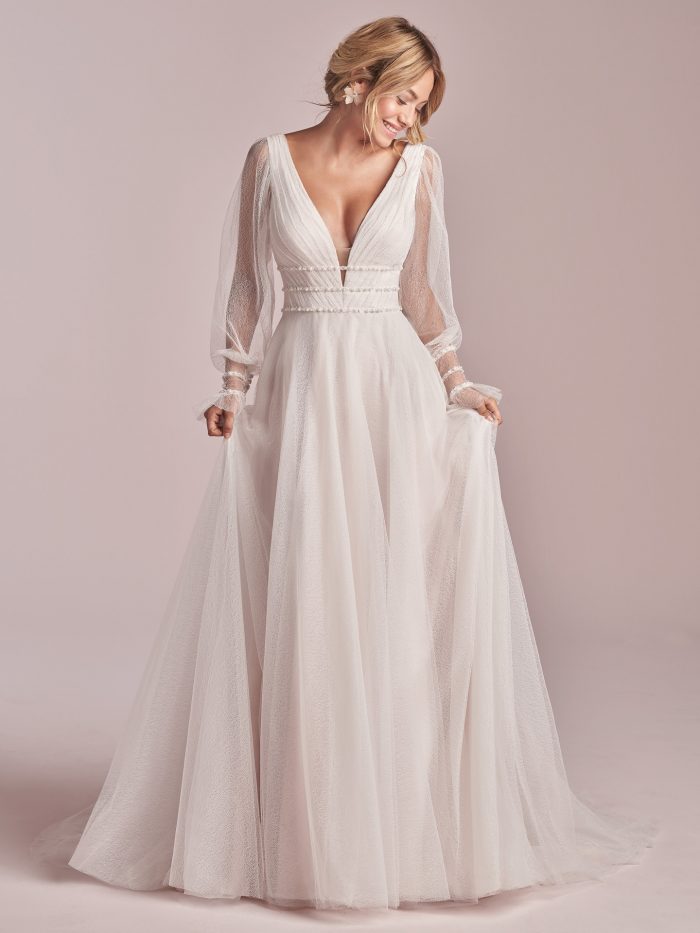 Model Wearing Sheer Bishop Sleeve A-line Wedding Dress Called Joanne by Rebecca Ingram