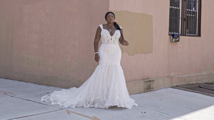 Black Model Wearing Plus Size Mermaid Lace Wedding Gown Called Joss by Sottero and Midgley 