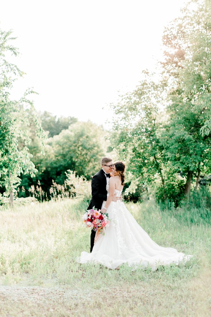 Groom in Rustic Meadow with Bride Wearing Boho Ball Gown Wedding Dress Called Zareen by Maggie Sottero