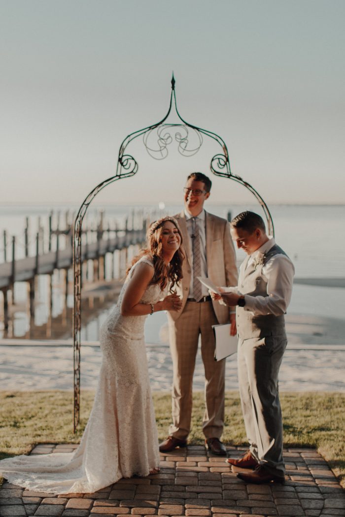 Bride and Groom on Beach Getting Married in Front of Friends and Family