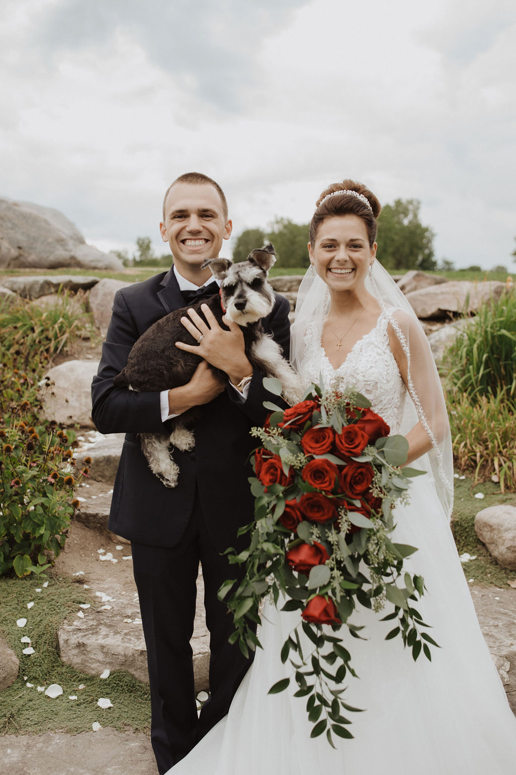 Bride and Groom Standing with Their Dog