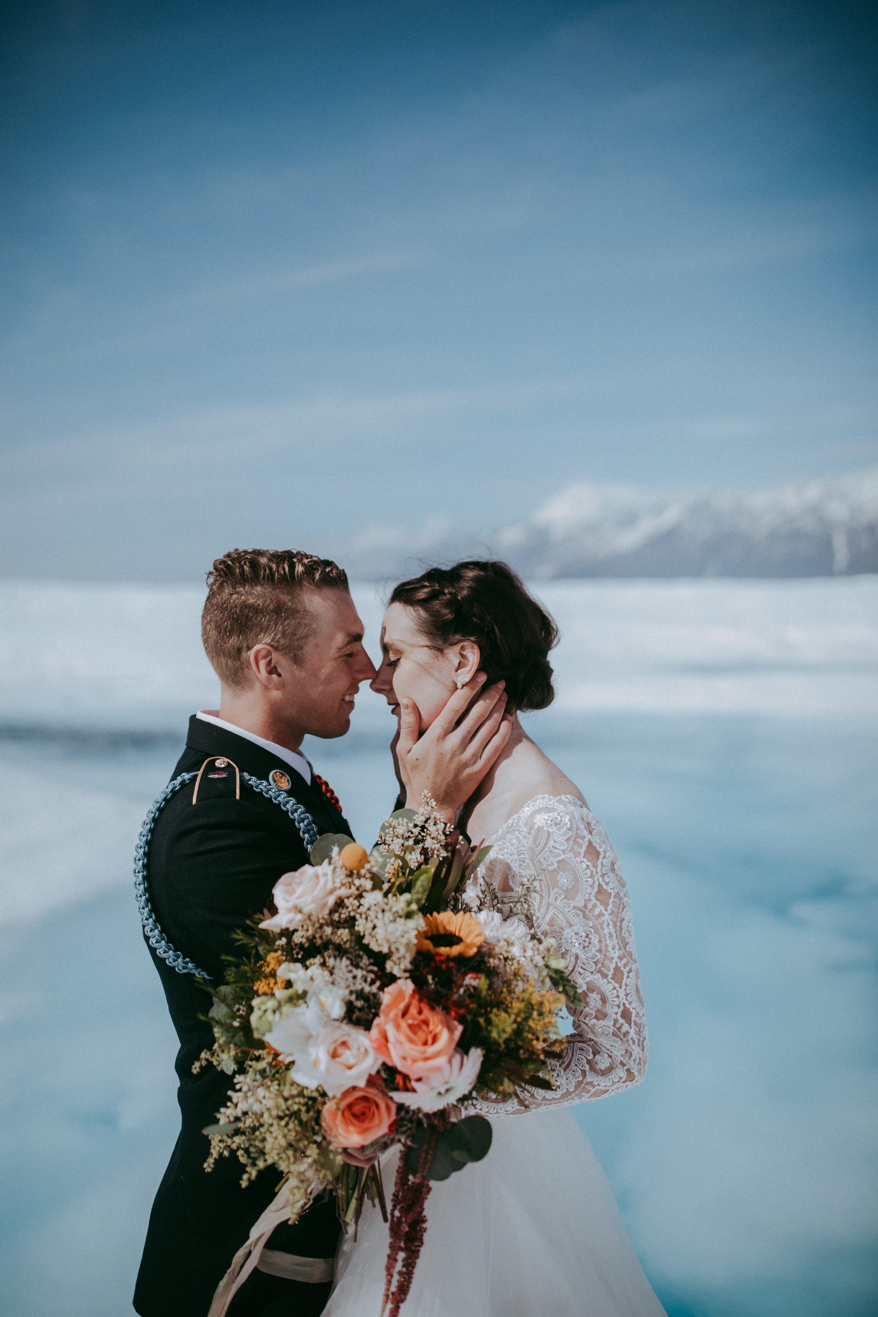 Groom with Real Bride Wearing Lace Ball Gown Wedding Dress Called Mallory Dawn by Maggie Sottero on Glacier in Alaska