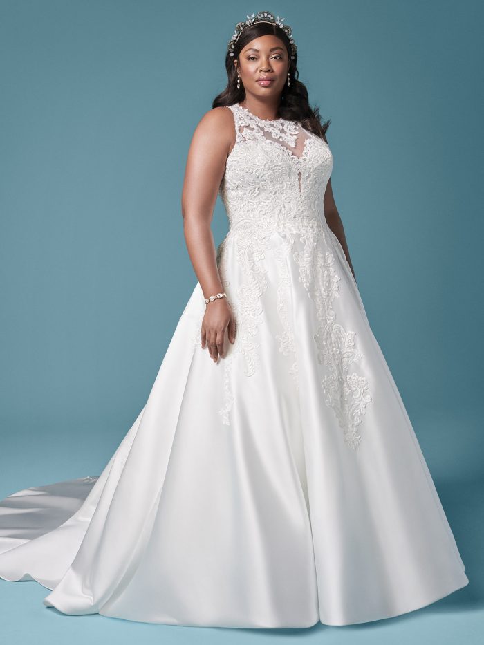Plus Size Model Wearing Plus Size Embroidered Satin Ball Gown Wedding Dress Called Tamika by Maggie Sottero