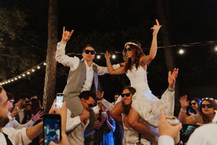 Bride and Groom Getting Carried on Shoulders at Wedding Party