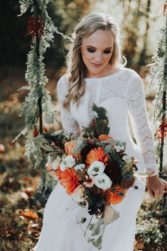 Boho Bride Wearing Boho Lace Bridal Gown and Sitting on Swing