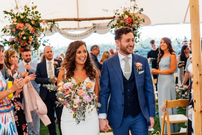 Bride and Groom Leaving Jewish Wedding Ceremony as Wedding Guests Watch