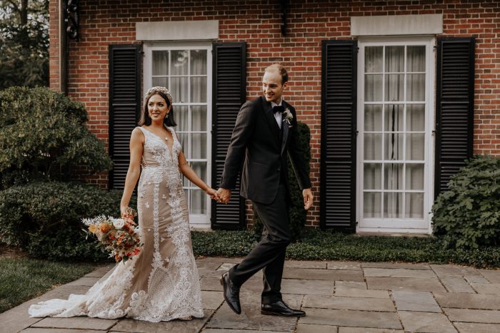 Groom Walking with Bride Wearing Lace Sheath Wedding Dress Called Agata Louise by Sottero and Midgley