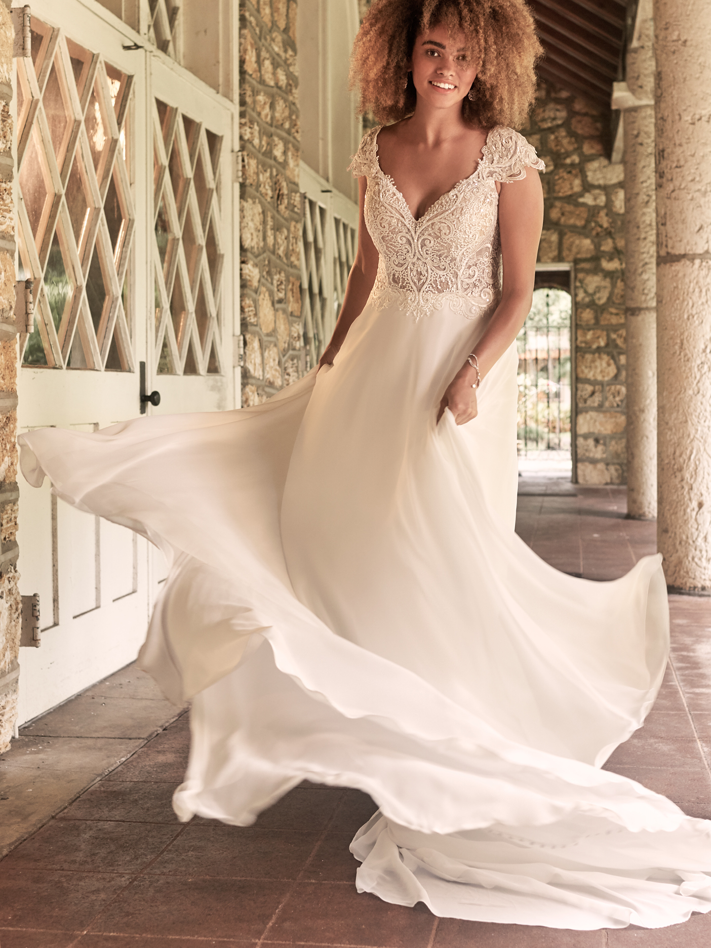 Model Wearing Boho Cap-Sleeve Chiffon Wedding Gown Called June by Maggie Sottero